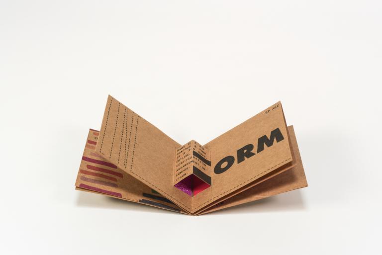 Artist book open to a pop-up page with the text "form"